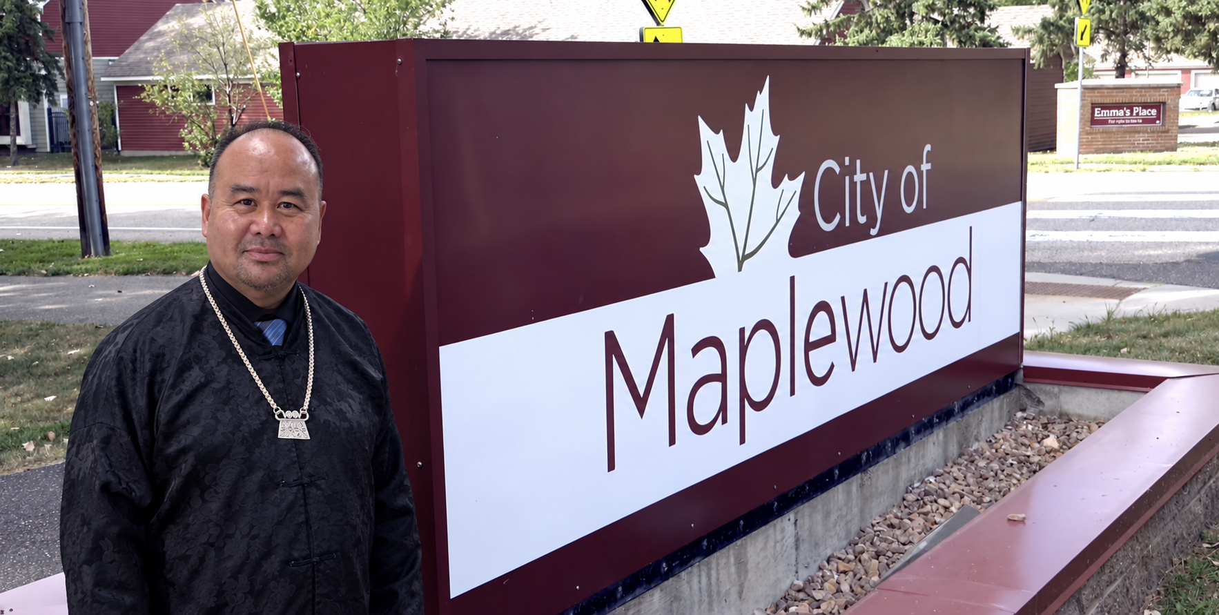 Photo composite of Tzianeng Vang beside the City of Maplewood sign